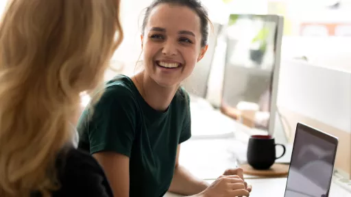Happy millennial intern, student girl talking to teacher, consulting tutor,